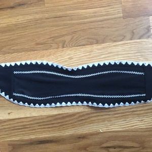 Black and with strapless bathing suit top